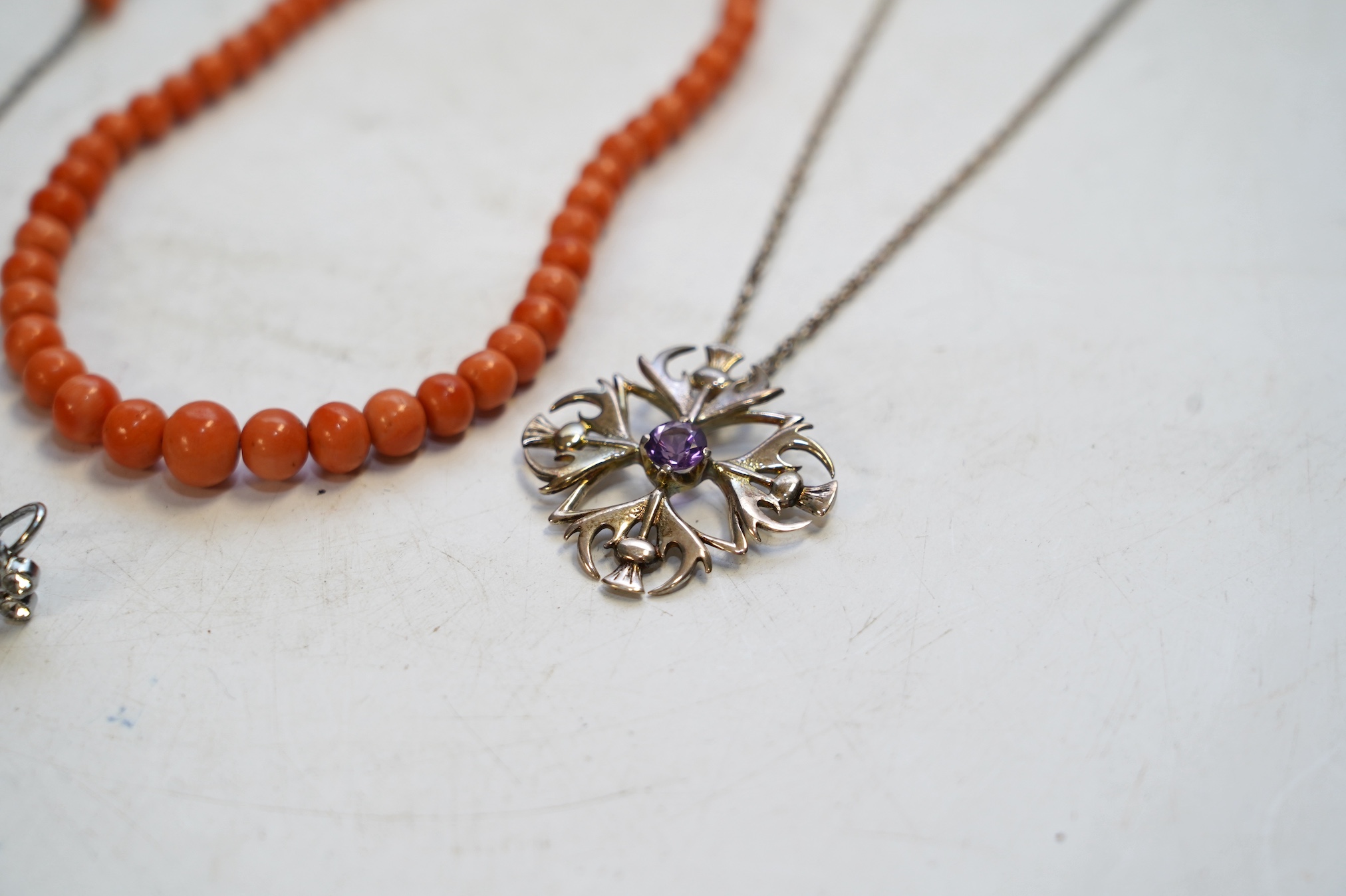 A Victorian yellow metal crucifix on a yellow metal chain, a coral necklace and other assorted jewellery. Condition - fair to poor